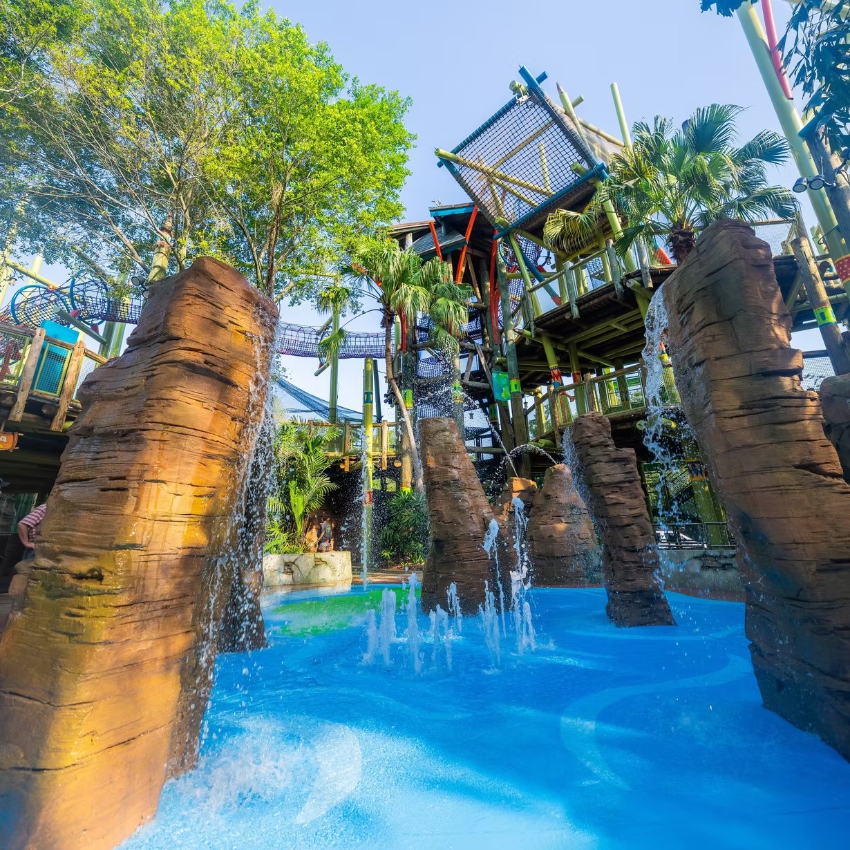 Sculpted and painted rockwork columns in a water park splash pool