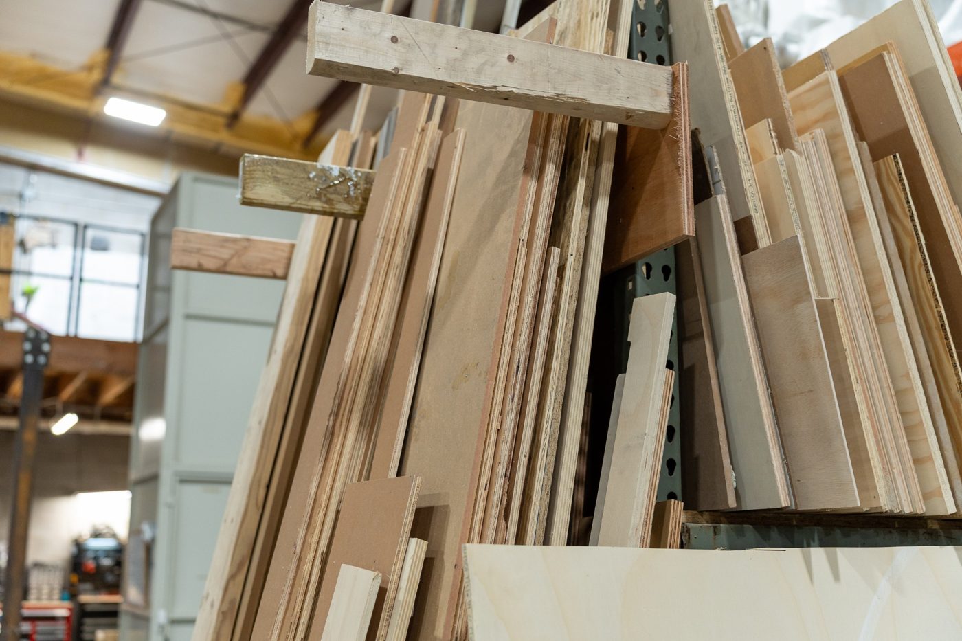 A rack of plywood, MDF and lumber offcuts standing on end