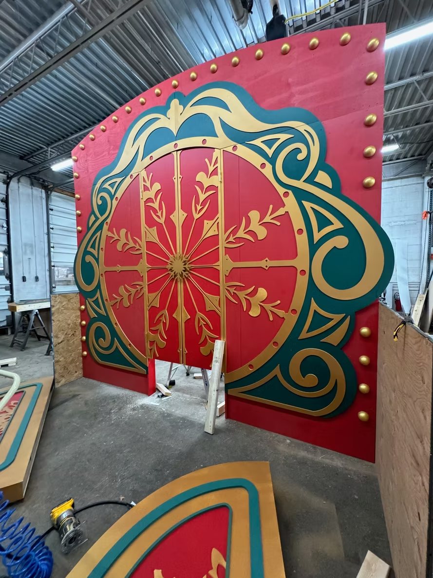 A red, teal and gold carousel-style double door facade in the shop