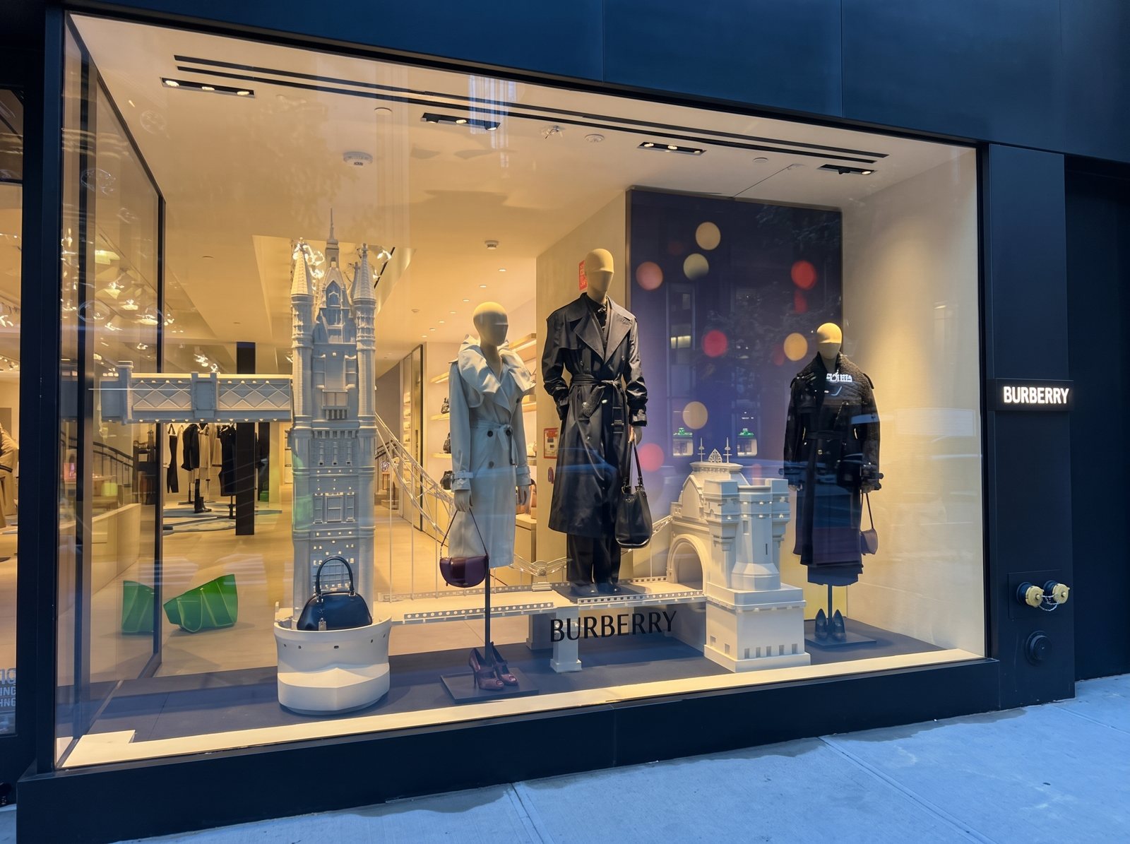 A Burberry window display with mannequins and a white sculpted tower